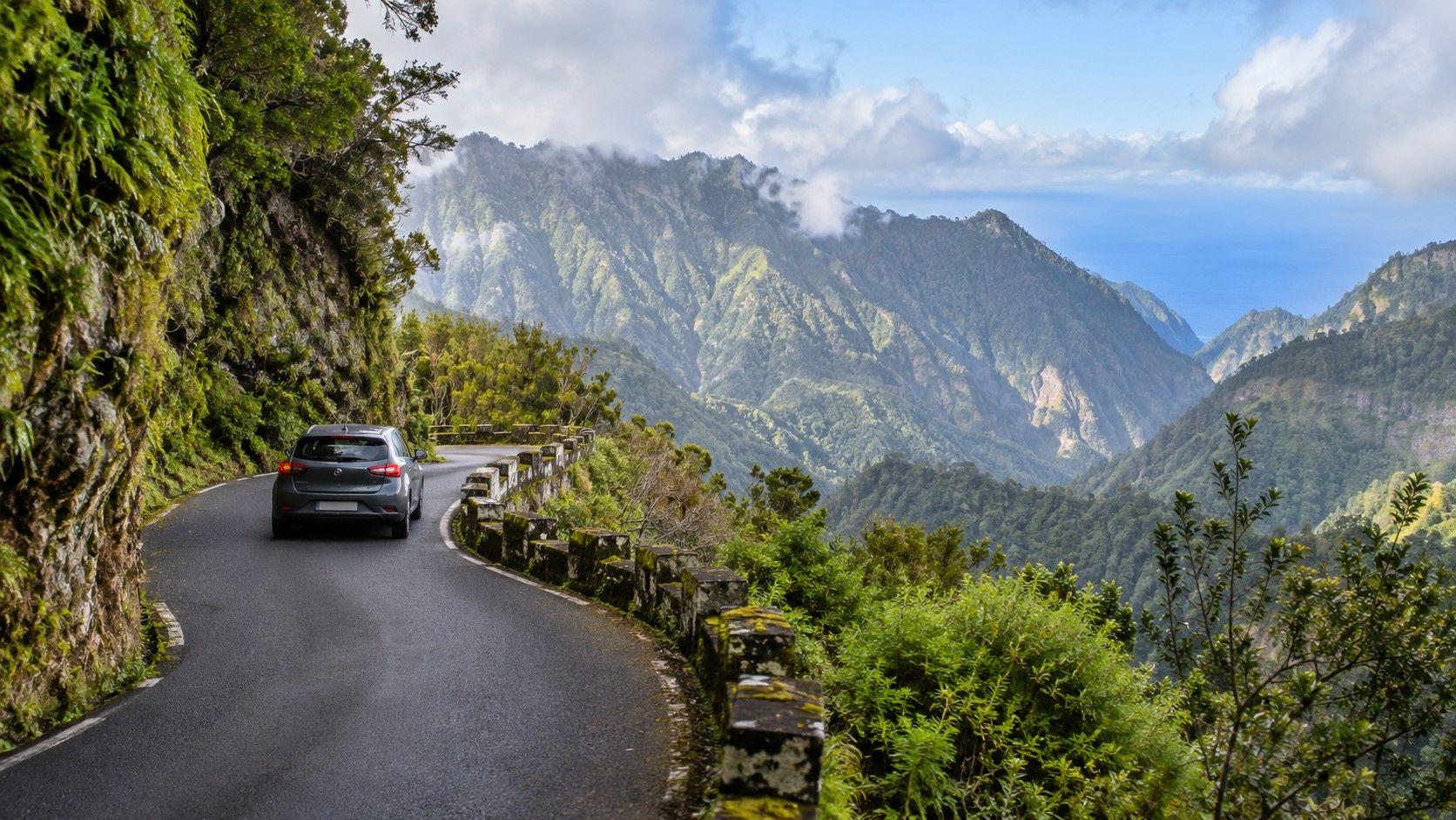Car on a winding Madeira mountain road